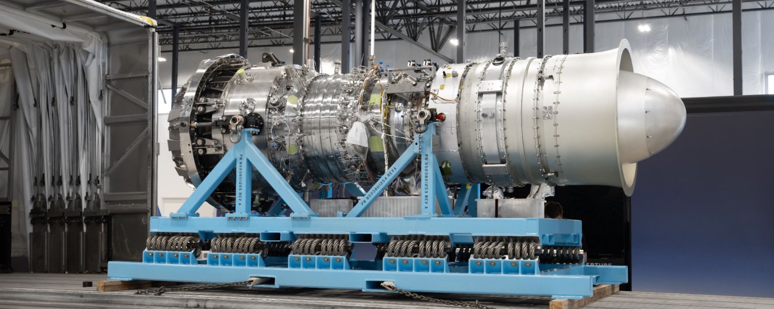 Boom Supersonic engine on a blue stand in a factory