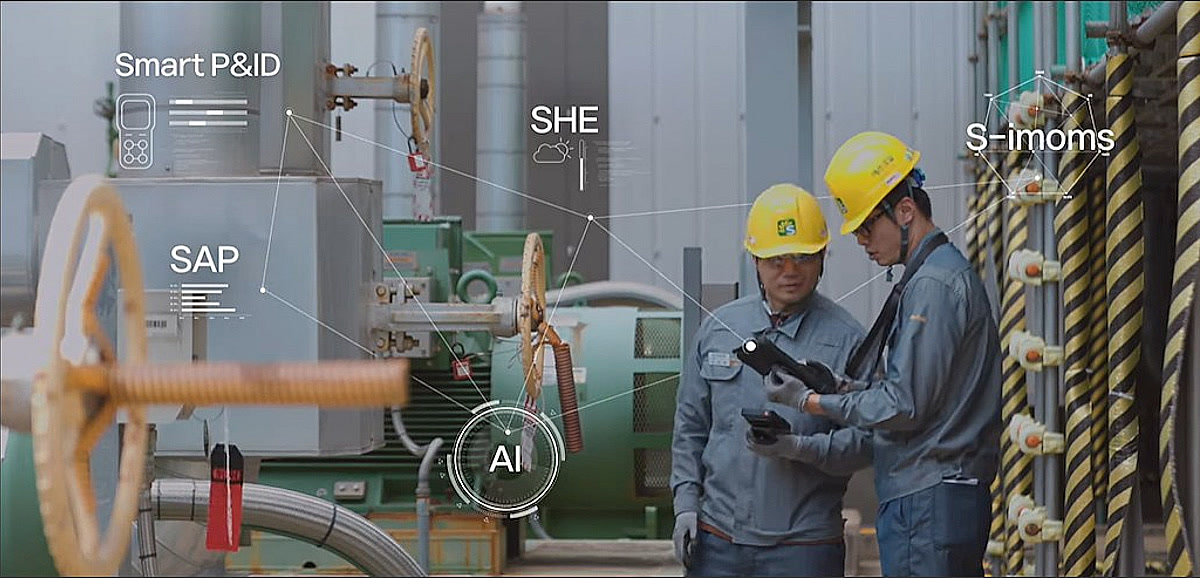 Operators at a console of screens in a refinery control room
